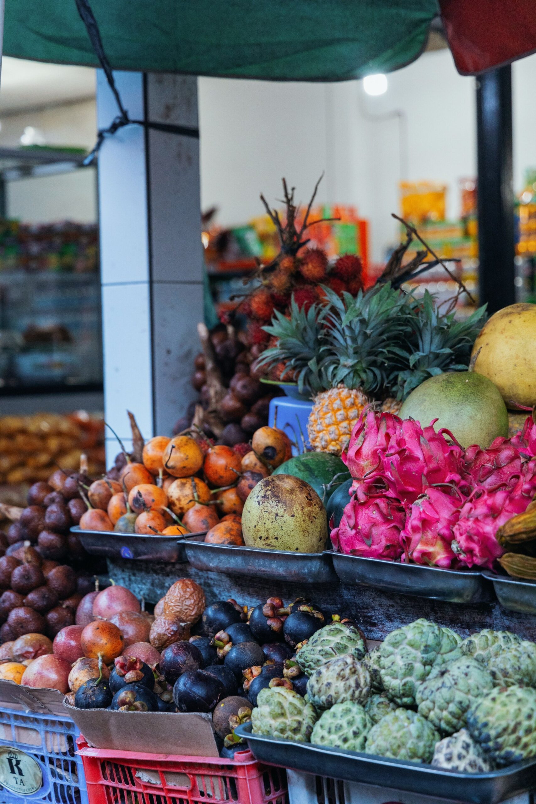 A vibrant selection of exotic fruits on display at an open market stand.